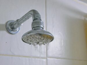 partly clogged shower head in a bathroom
