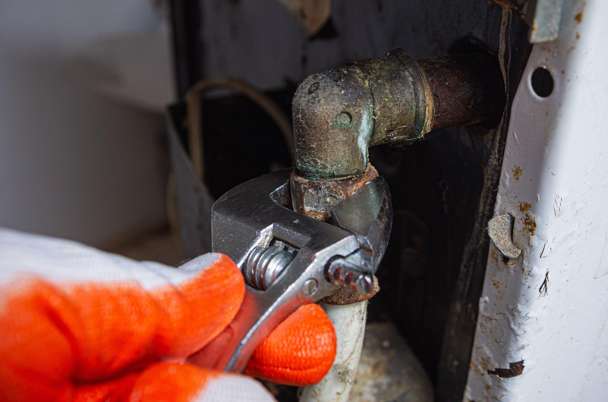 Disconnecting a gas pipe in an old gas kitchen stove.
